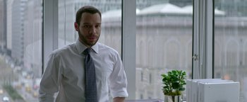 Movie still from “tick, tick... BOOM!” (2021), directed by Lin-Manuel Miranda – A man in a white shirt and tie standing in front of a window; Medium shot, Over the shoulder angle