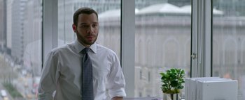 Movie still from “tick, tick... BOOM!” (2021), directed by Lin-Manuel Miranda – A man wearing a white shirt and a gray tie; Medium shot, Over the shoulder angle