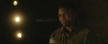 Movie still from “tick, tick... BOOM!” (2021), directed by Lin-Manuel Miranda – A man standing in front of a microphone in a dark room; Close Up shot, Over the shoulder angle