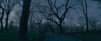 Movie still from “tick, tick... BOOM!” (2021), directed by Lin-Manuel Miranda – A person walking down a path in a park at night; Extreme Wide shot, High angle