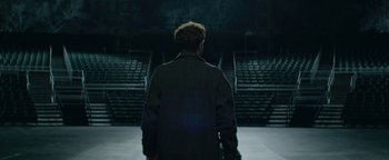 Movie still from “tick, tick... BOOM!” (2021), directed by Lin-Manuel Miranda – A man standing in front of an audience in an arena; Wide shot, High angle