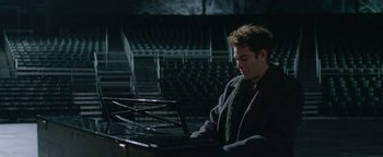 Movie still from “tick, tick... BOOM!” (2021), directed by Lin-Manuel Miranda – A man sitting in front of an open laptop; Medium shot, High angle