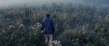 Movie still from “Solaris” (1972), directed by Andrei Tarkovsky – A man walking through a field of tall grass; Wide shot, High angle