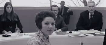 Movie still from “Solaris” (1972), directed by Andrei Tarkovsky – A woman sitting in front of two men in a room; Close Up shot, Low angle
