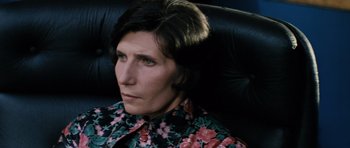 Movie still from “Solaris” (1972), directed by Andrei Tarkovsky – A person sitting in a chair wearing a floral shirt; Close Up shot, High angle