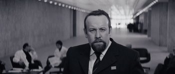 Movie still from “Solaris” (1972), directed by Andrei Tarkovsky – A black and white photo of a man in a suit and tie; Close Up shot, Low angle