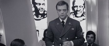 Movie still from “Solaris” (1972), directed by Andrei Tarkovsky – A man in a military uniform holding a glass; Close Up shot, Low angle