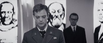 Movie still from “Solaris” (1972), directed by Andrei Tarkovsky – A man standing in front of a painting of an old man; Medium shot, Over the shoulder angle