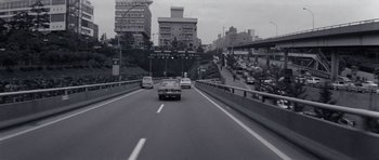 Movie still from “Solaris” (1972), directed by Andrei Tarkovsky – A black and white photo of cars driving down a street; Extreme Wide shot, High angle