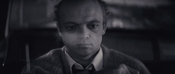 Movie still from “Solaris” (1972), directed by Andrei Tarkovsky – A black and white photo of a man in a sweater and tie; Close Up shot, High angle