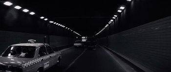 Movie still from “Solaris” (1972), directed by Andrei Tarkovsky – Cars driving down a dark road in a tunnel; Wide shot, Low angle