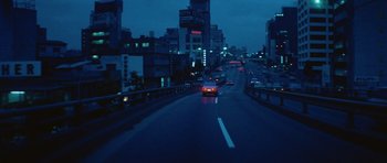 Movie still from “Solaris” (1972), directed by Andrei Tarkovsky – Cars driving down a city street at night time; Extreme Wide shot, High angle
