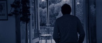 Movie still from “Solaris” (1972), directed by Andrei Tarkovsky – A man sitting on a chair looking out a window; Medium shot, High angle