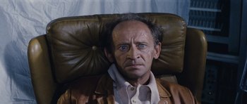 Movie still from “Solaris” (1972), directed by Andrei Tarkovsky – An older man with blue eyes sitting in a chair; Close Up shot, High angle