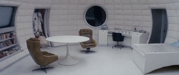 Movie still from “Solaris” (1972), directed by Andrei Tarkovsky – A room with a table , chairs , and a round mirror in it; Wide shot, High angle