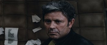 Movie still from “Solaris” (1972), directed by Andrei Tarkovsky – A person wearing a suit and tie; Close Up shot, High angle