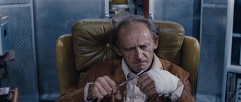 Movie still from “Solaris” (1972), directed by Andrei Tarkovsky – An older man sitting in a chair with a knife in his hand; Close Up shot, High angle