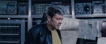 Movie still from “Solaris” (1972), directed by Andrei Tarkovsky – An older man wearing a leather jacket looking to his left; Medium shot, Over the shoulder angle