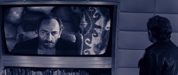 Movie still from “Solaris” (1972), directed by Andrei Tarkovsky – A man sitting in front of a television; Close Up shot, Over the shoulder angle