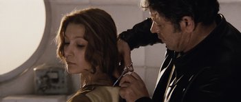 Movie still from “Solaris” (1972), directed by Andrei Tarkovsky – A man cutting a woman's hair with a pair of scissors; Close Up shot, Over the shoulder angle