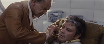 Movie still from “Solaris” (1972), directed by Andrei Tarkovsky – A man is touching another man's head in a room; Close Up shot, Low angle