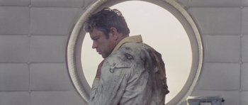 Movie still from “Solaris” (1972), directed by Andrei Tarkovsky – A man in a white jacket standing in front of a circular window; Medium shot, Low angle