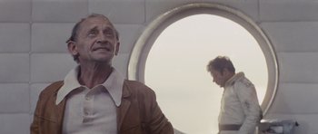 Movie still from “Solaris” (1972), directed by Andrei Tarkovsky – An older man standing in front of an airplane window; Close Up shot, Low angle