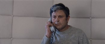 Movie still from “Solaris” (1972), directed by Andrei Tarkovsky – A man in a gray shirt is talking on a phone; Close Up shot, Low angle