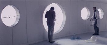 Movie still from “Solaris” (1972), directed by Andrei Tarkovsky – A man standing in front of a large round window; Wide shot, Low angle