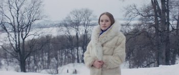 Movie still from “Solaris” (1972), directed by Andrei Tarkovsky – A woman in a white coat standing in the snow; Medium shot, High angle