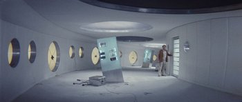 Movie still from “Solaris” (1972), directed by Andrei Tarkovsky – A man standing in an empty room with clocks on the wall; Wide shot, High angle