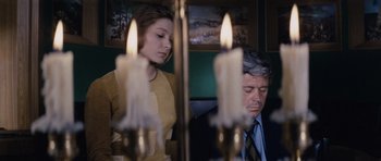Movie still from “Solaris” (1972), directed by Andrei Tarkovsky – A man and a woman standing in front of candles; Medium shot, Low angle