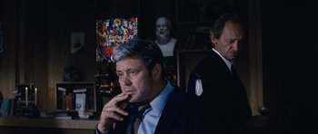 Movie still from “Solaris” (1972), directed by Andrei Tarkovsky – A man in a suit and tie standing next to another man in a suit and tie; Medium shot, Over the shoulder angle