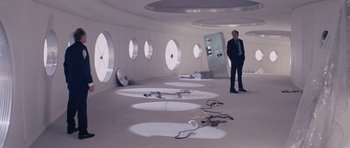 Movie still from “Solaris” (1972), directed by Andrei Tarkovsky – A man in a suit standing in front of a window; Wide shot, High angle