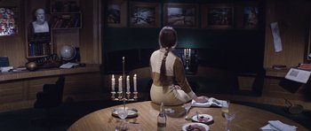 Movie still from “Solaris” (1972), directed by Andrei Tarkovsky – A woman sitting at a round table with candles; Wide shot, High angle