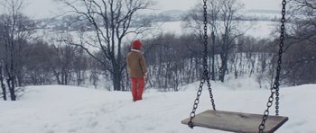 Movie still from “Solaris” (1972), directed by Andrei Tarkovsky – A person standing in the snow next to a wooden swing; Extreme Wide shot, High angle