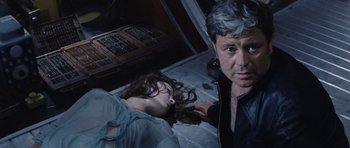 Movie still from “Solaris” (1972), directed by Andrei Tarkovsky – A man and a woman laying on the floor; Medium shot, Overhead angle