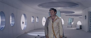 Movie still from “Solaris” (1972), directed by Andrei Tarkovsky – A man standing in a room with a lot of windows; Medium shot, Low angle