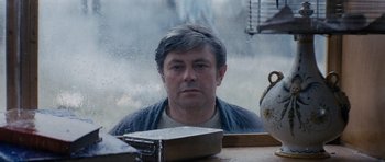Movie still from “Solaris” (1972), directed by Andrei Tarkovsky – A man sitting in front of a window; Close Up shot, Over the shoulder angle