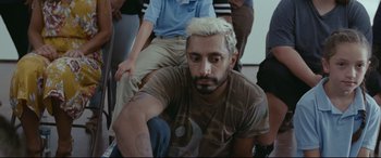Movie still from “Sound of Metal” (2019), directed by Darius Marder – A man with white hair sitting on the ground; Close Up shot, High angle