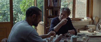 Two people sitting at a table eating food