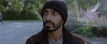 A person with a beard wearing a hat