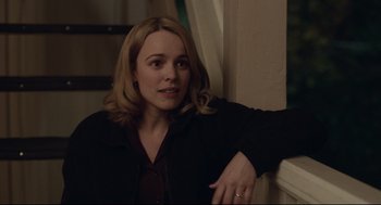 Movie still from “Spotlight” (2015), directed by Tom McCarthy – A woman leaning against a wall with her hand on her shoulder; Medium shot, Over the shoulder angle