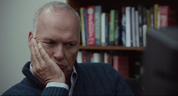 Movie still from “Spotlight” (2015), directed by Tom McCarthy – An older man sitting in front of a book shelf; Close Up shot, Over the shoulder angle