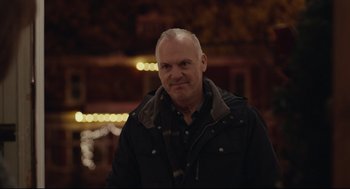 Movie still from “Spotlight” (2015), directed by Tom McCarthy – A man in a black jacket standing in front of lights; Close Up shot, Over the shoulder angle