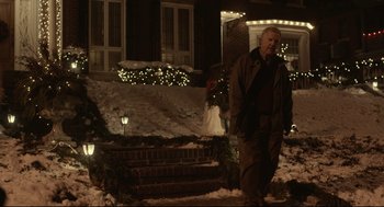 Movie still from “Spotlight” (2015), directed by Tom McCarthy – A man walking down a snowy sidewalk at night; Wide shot, Over the shoulder angle