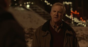 Movie still from “Spotlight” (2015), directed by Tom McCarthy – An older man standing in the snow at night; Close Up shot, Over the shoulder angle