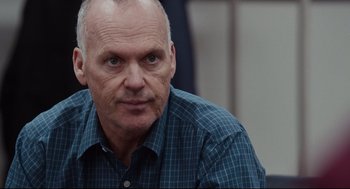 Movie still from “Spotlight” (2015), directed by Tom McCarthy – An older man wearing a plaid shirt looking into the camera; Close Up shot, Over the shoulder angle