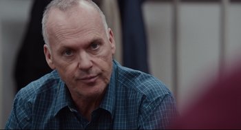 Movie still from “Spotlight” (2015), directed by Tom McCarthy – An older man in a plaid shirt is looking at the camera; Close Up shot, Over the shoulder angle