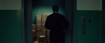 Movie still from “Steve Jobs” (2015), directed by Danny Boyle – A man standing in front of boxes in a room; Medium shot, Low angle